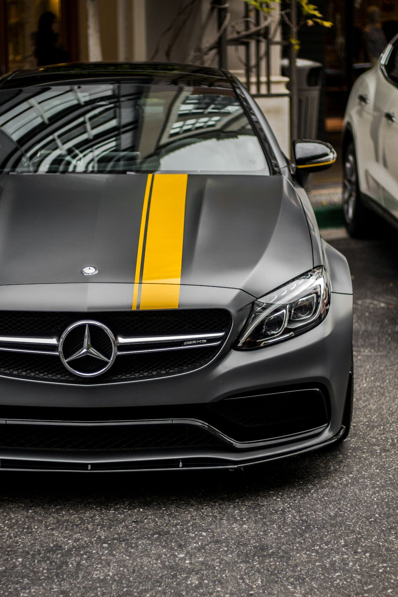 Matte grey Mercedes-AMG with yellow racing stripe